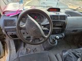 a dirty dashboard of a car with a bunch of items on the dashboard