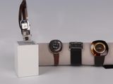 three watches on display on a white display stand