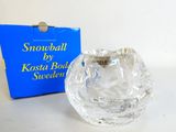 an image of a glass candle holder with a box in the background