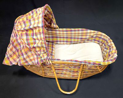 an image of a wicker basket with a blanket on top of it
