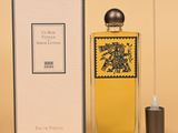 an image of a bottle of perfume sitting next to a box