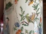 a vase that has a bird and flowers on it