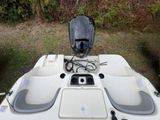 a white boat with a motor on the back of it