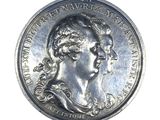 an old silver coin with a portrait of a woman on it