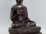 bronze statue of a seated buddha on a lotus flower base