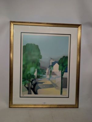 tableau encadré représentant une rue avec des maisons et des arbres