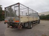 a truck with a cage on the back parked in a parking lot