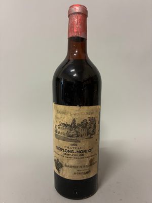 an old bottle of wine sitting on top of a table