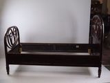 a bed with a wooden frame on a white surface
