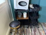 a microwave and a chair in the corner of a room