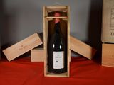 a bottle of wine in a wooden box on a table