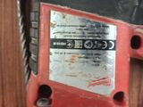 an image of a corded drill with a hammer on top of it