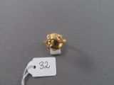 a gold ring with a lion head on it and a price tag attached to it