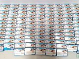 a lot of boxes of toothpaste sitting on a table