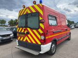 a red van with yellow and red stripes parked in a parking lot