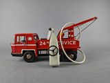 a toy fire truck with a hose attached to the back of it
