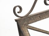 a metal bench that has a metal frame on top of it