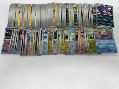 a lot of pokemon trading cards on the table