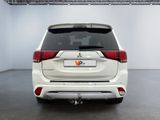 the rear end of a white suv parked in a garage