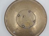an image of a gold plate on a white surface