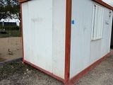 a small white building with a red trim on it