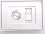 a white box with a charger and a cell phone in it