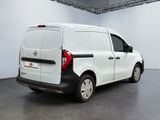 the back of a white van parked inside of a building
