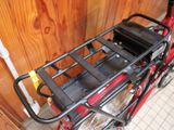 a red bicycle with a black basket on it
