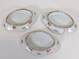 three pieces of porcelain dishes are sitting on a white surface
