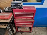 a red tool cabinet with a few tools on top of it