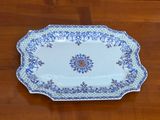 a blue and white platter sitting on a wooden table