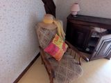 a chair in the corner of a room with a pillow on it