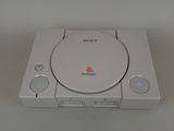 the sony playstation is sitting on top of a white table