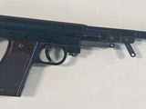 a toy gun on a table with a white background