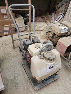 a small machine that is sitting in the middle of a pile of boxes