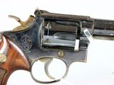 an old gun with a wooden handle on a white surface