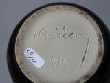 a close up of a vase with a tag on it