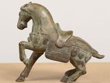 an old bronze statue of a horse with a saddle on it ' s back