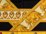 a picture of a gold and black scarf with elephants on it