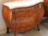 two wooden dressers sitting next to each other in a room