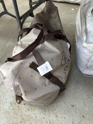two bags of luggage sitting on the ground next to each other