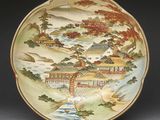 a plate with a painting on it on a table