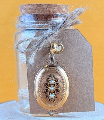 a small glass jar with a silver locke on it