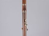 a close up of a wooden clarinet on display in a clear case