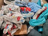 a cardboard box full of clothes and other items in it