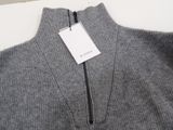 the back of a gray sweater with a tag on it