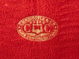 the red towel has a gold emblem on it