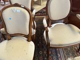 a man standing next to a group of chairs in a room