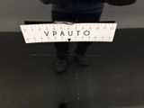 a person standing in front of a mirror holding a ruler