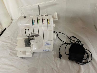 a sewing machine that is sitting on a white sheet